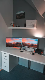 A neatly arranged desk with dual monitors and personalized tech accessories.
