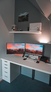 A sleek desktop computer setup with dual monitors on a modern office desk