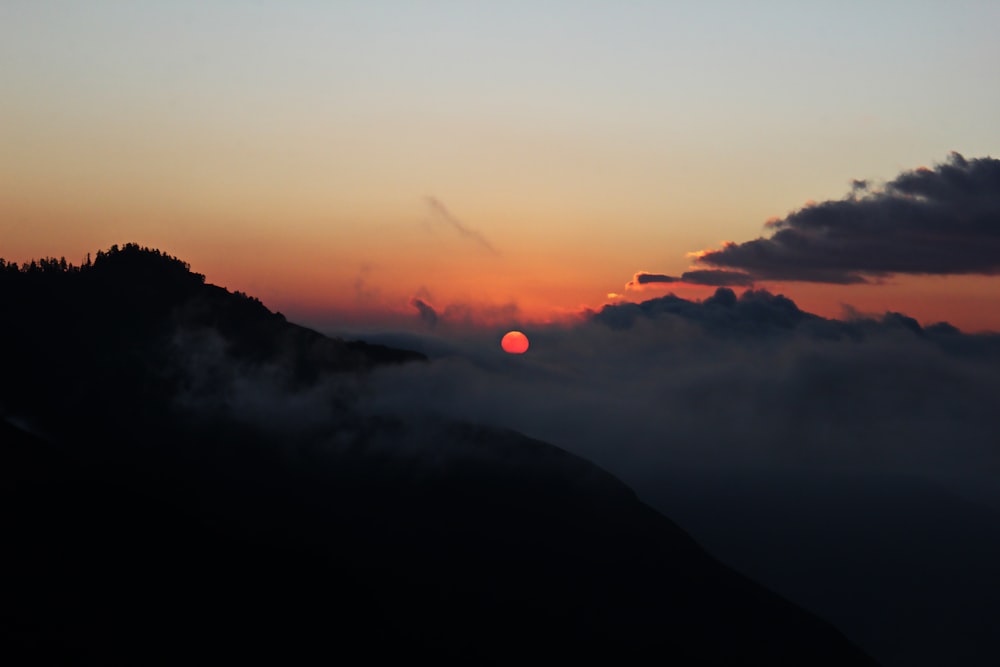 white sea of clouds sunset silhouette mountain scnery