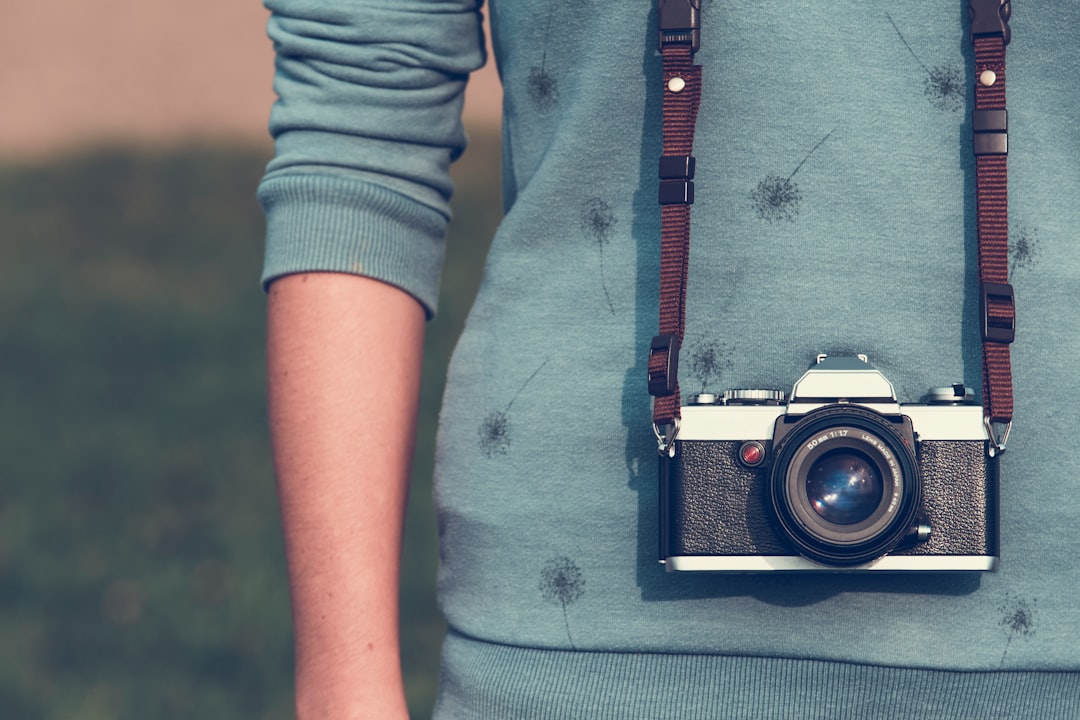 person wearing camera, Woman with vintage analog photo camera