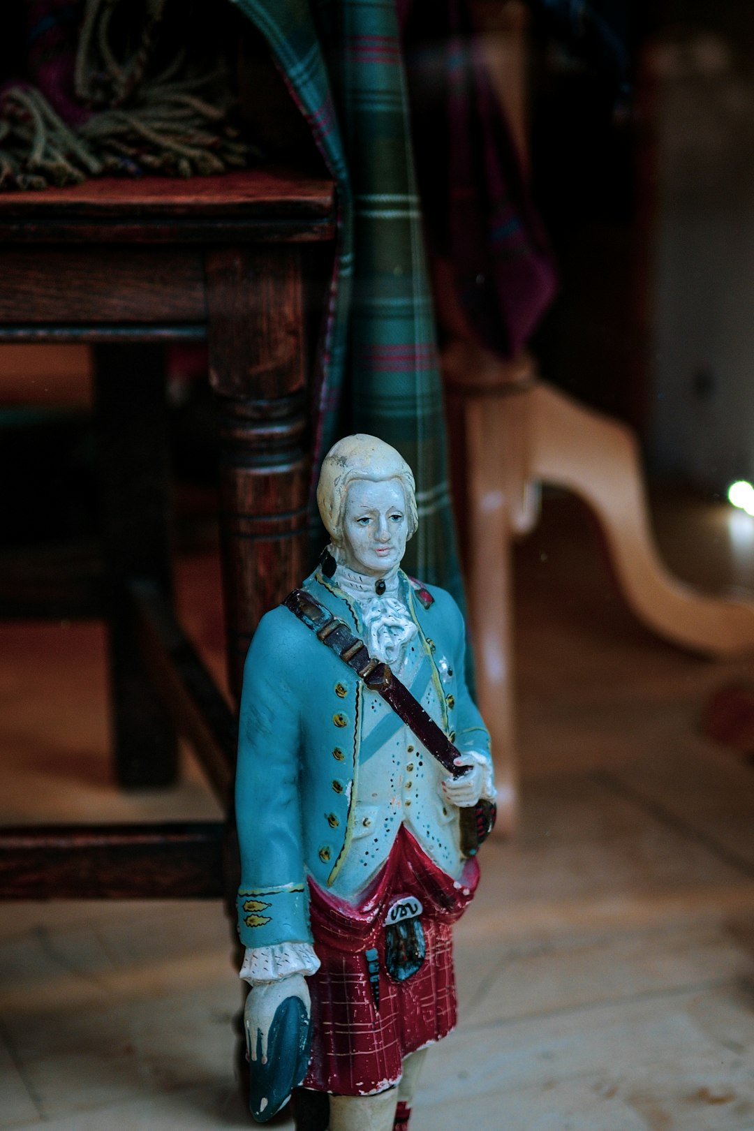 English man statuette on the floor near chair