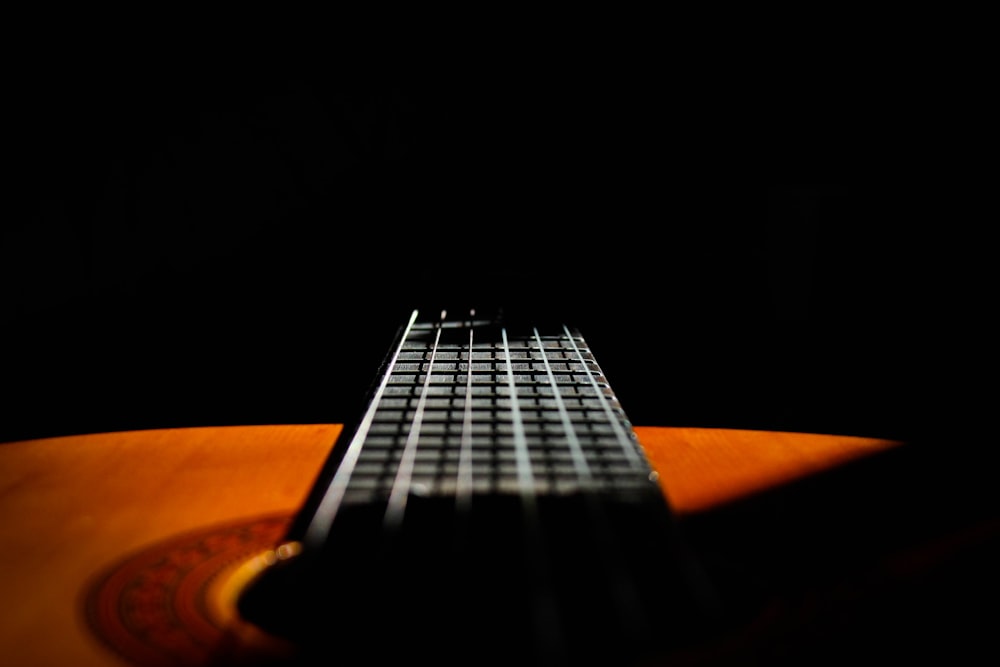 close-up photography of black and brown guitar