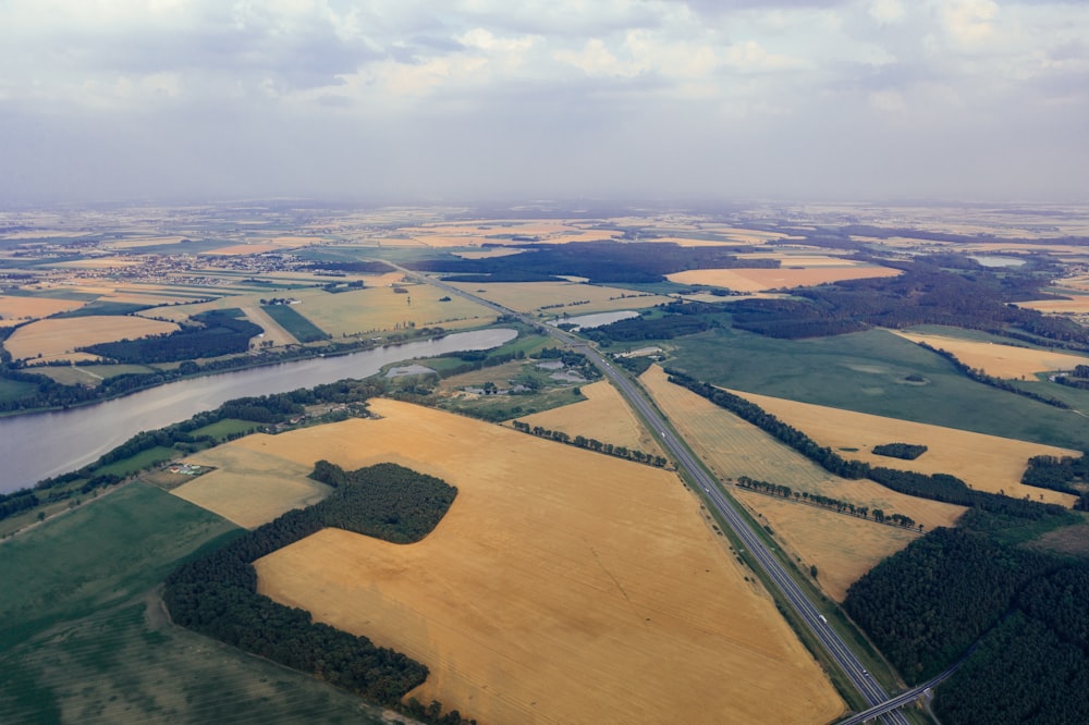 river, road, and field during day