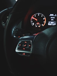 Close-up of a car dashboard showing a hands-free phone setup to avoid distractions.