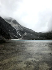 A serene landscape showing the pristine mountain source where Rain Drop mineral water is collected.