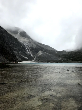 A serene landscape showing the pristine mountain source where Rain Drop mineral water is collected.