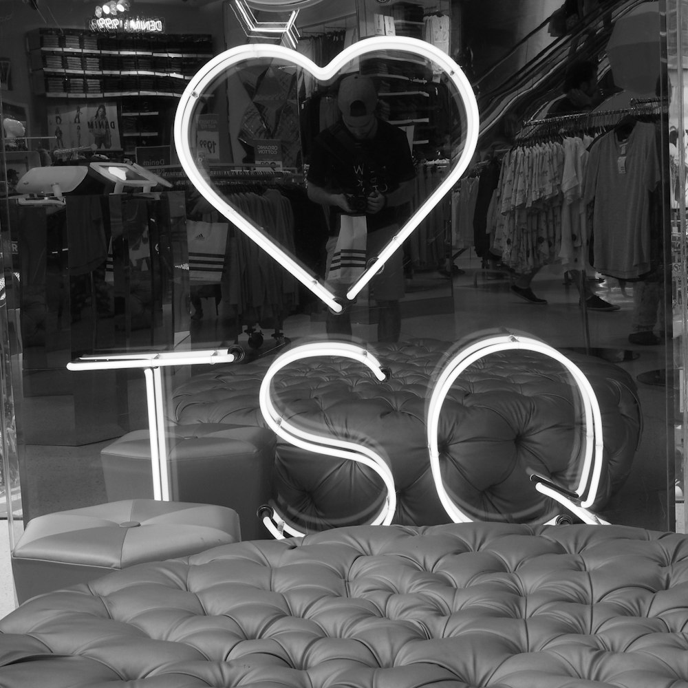 TSQ neon sign beside chair