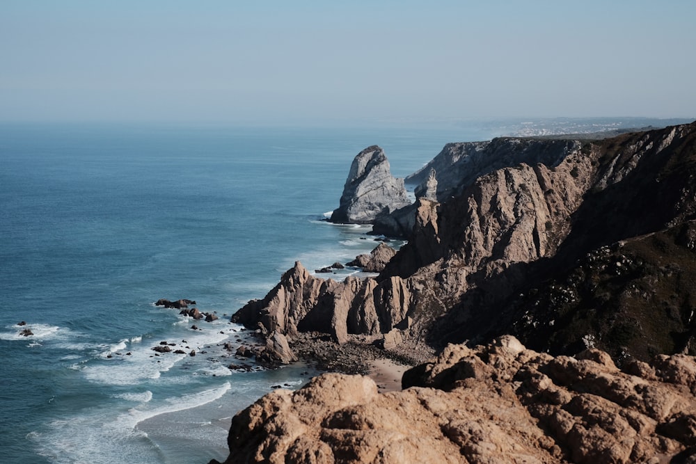 cliff and sea during daytime