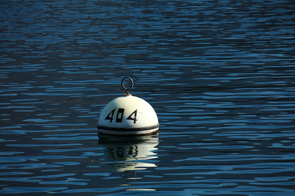 white and black 404 buoy during daytime