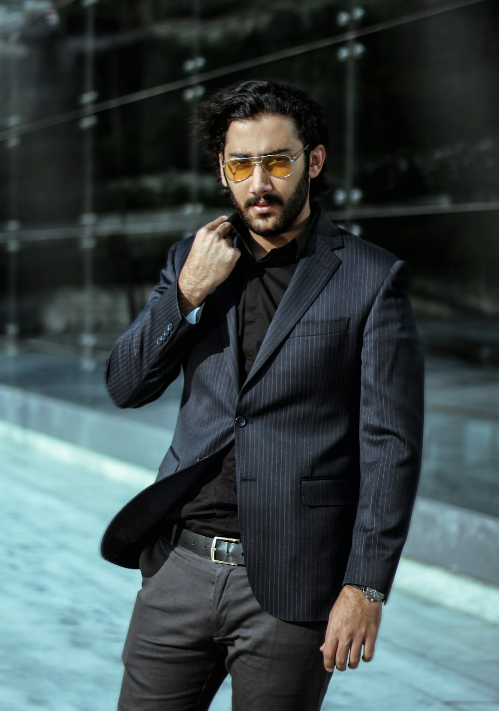 selective focus photography of standing man in black suit jacket