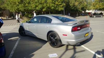 Front view of a sleek silver sedan parked on a sunny lot.
