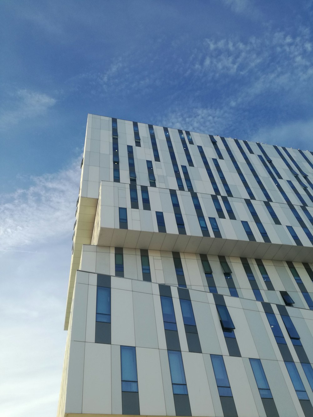 low-angle photography of gray and blue concrete building during daytime