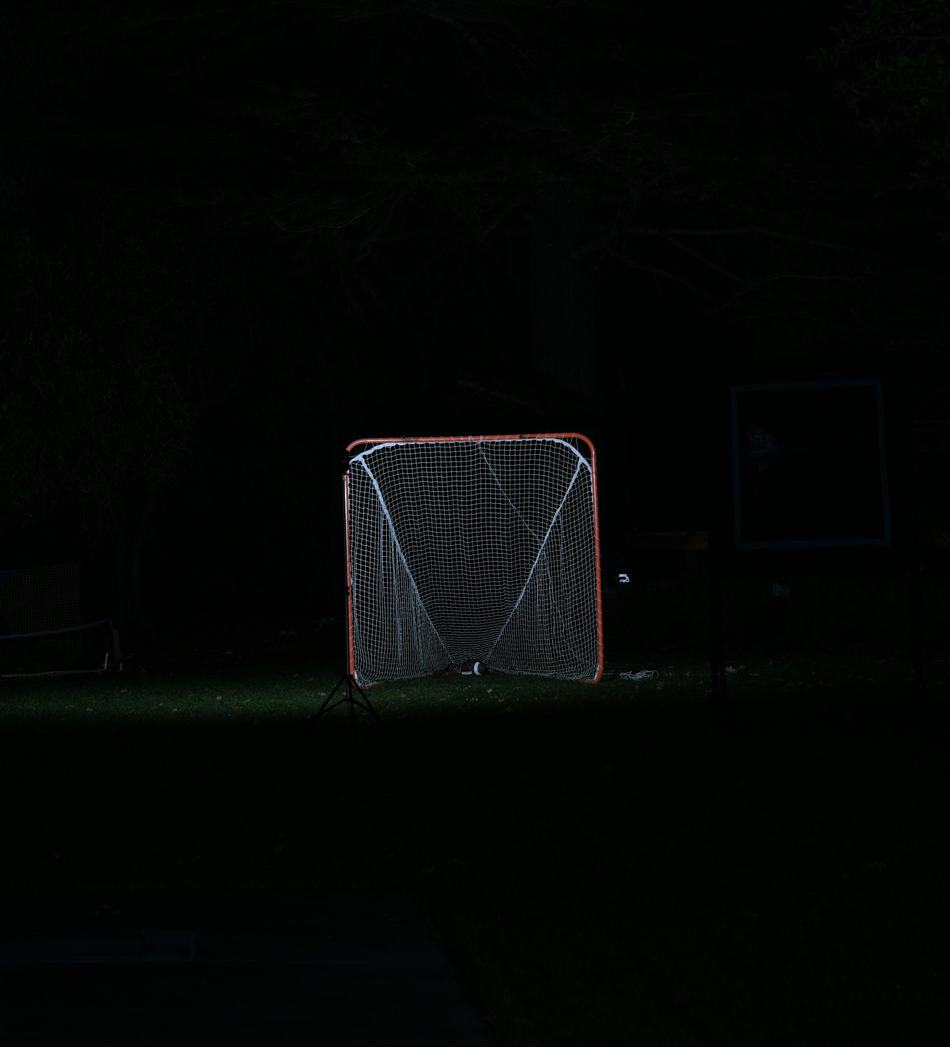 white and orange soccer goal during night time