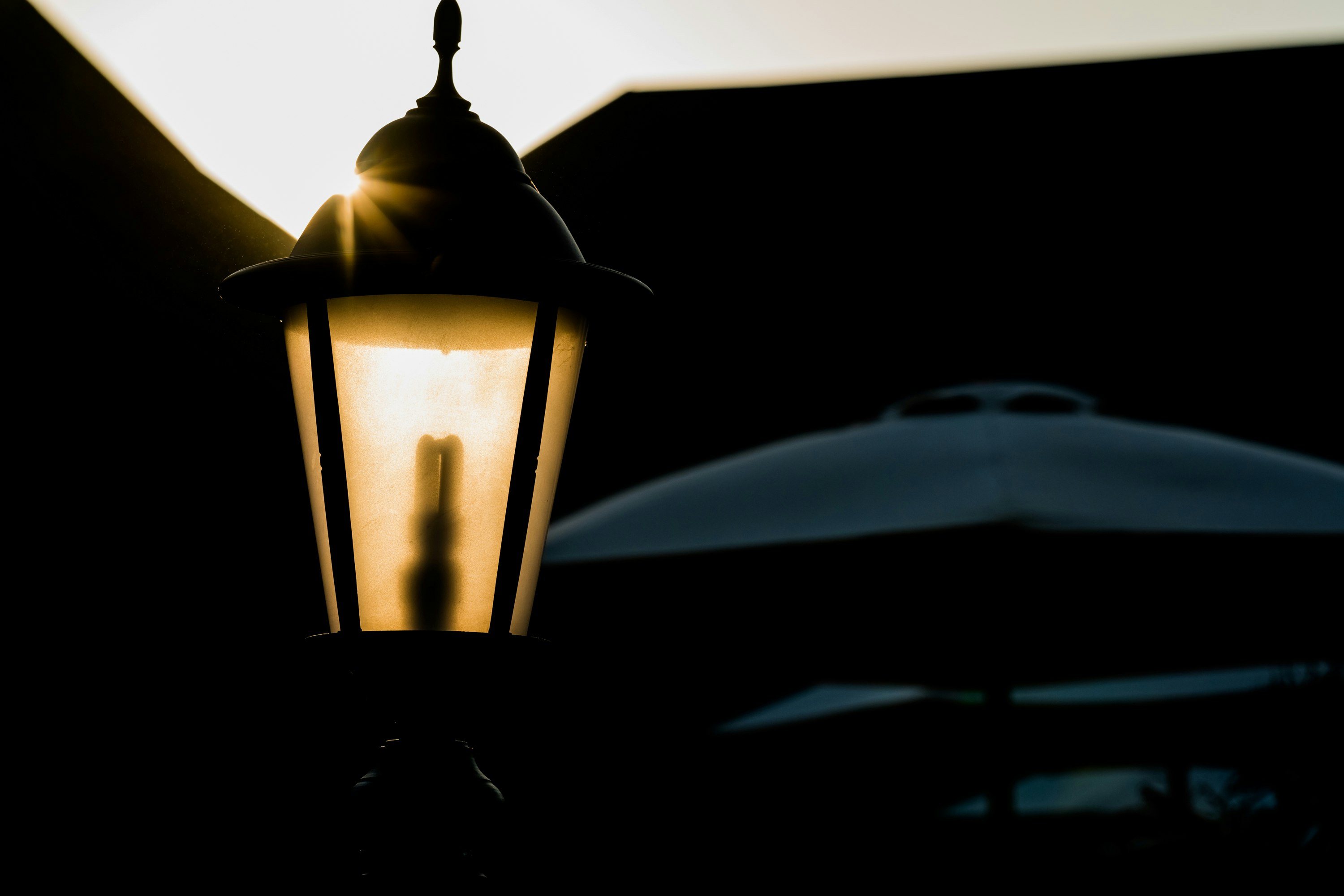 A lamp blocking a sunset.
Taken from White Sands, Dar es Salaam - Tanzania.