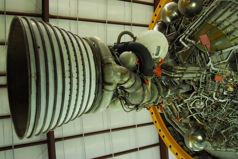 Close-up of a rocket engine prototype being assembled in a bright, modern lab.