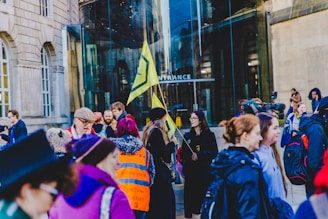 A group of people gathered outside a building under ICE surveillance.