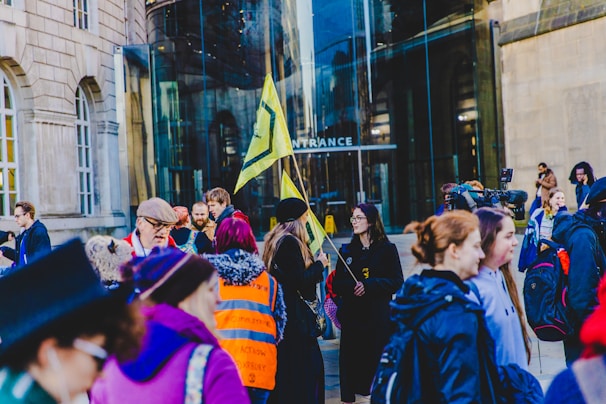 A group of people gathered outside a building under ICE surveillance.