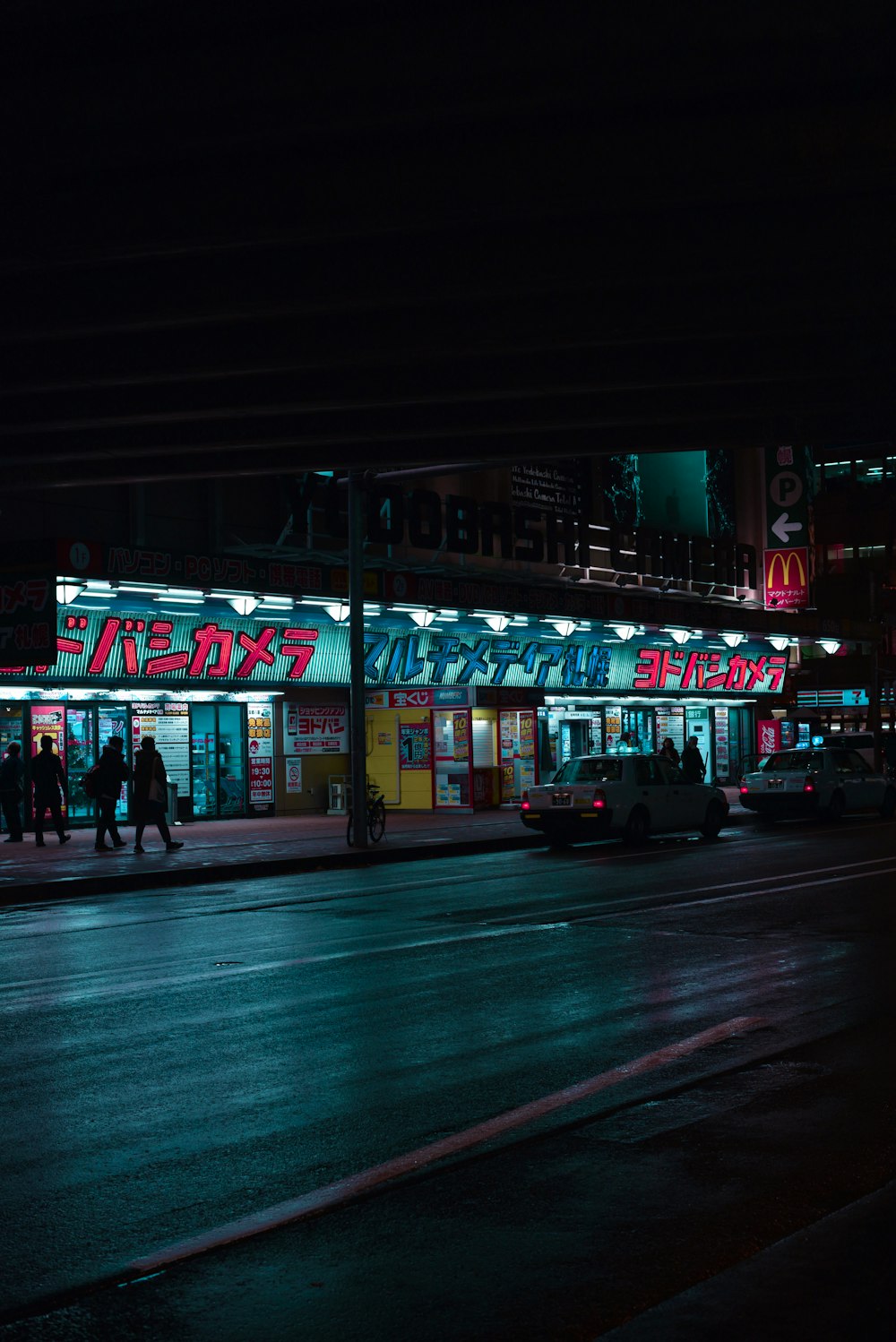 vehicles crossing road at night