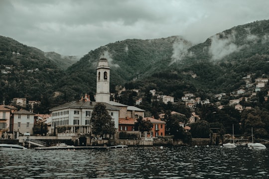 white and brown concrete buildings beside body of water in Como Italy