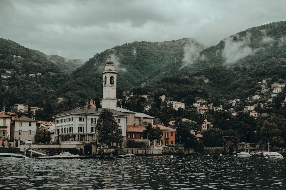 white and brown concrete buildings beside body of water