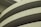 Curved sections of a concrete structure with visible lines and textures, likely part of a modern architectural building.
