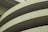Curved sections of a concrete structure with visible lines and textures, likely part of a modern architectural building.
