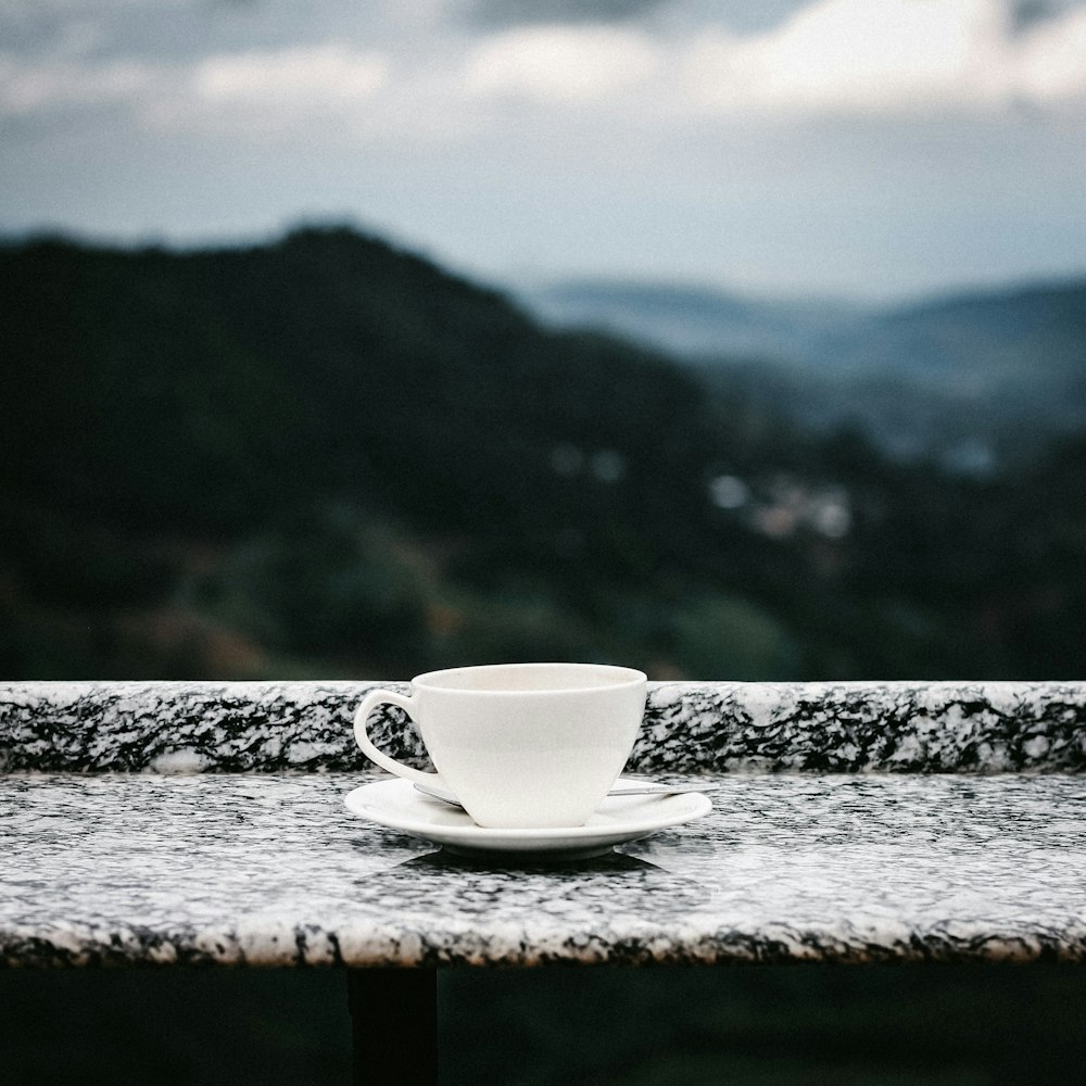 white teacup with saucer