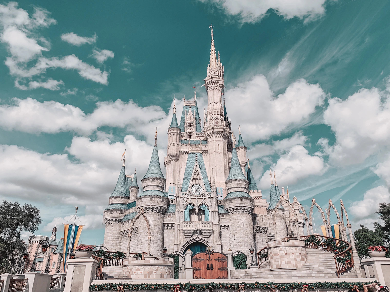 Cinderella Castle seen in full beneath a wide cloud-filled sky at Walt Disney World