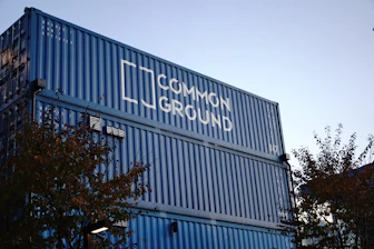Stacked site containers with Papua New Guinea landscape in the background