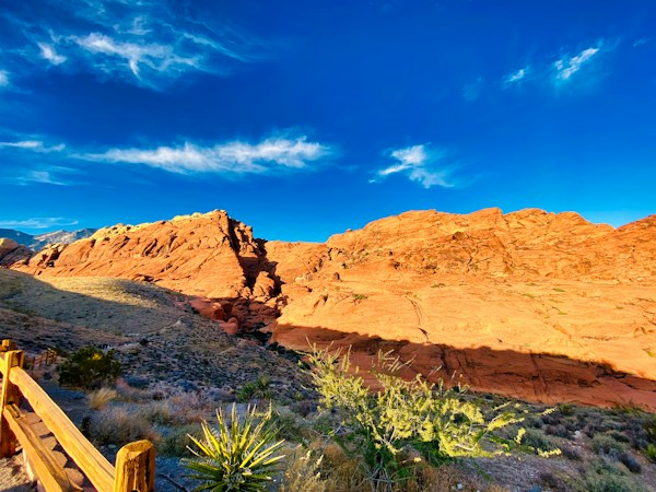 Red rock mountains near Las Vegas glowing at golden hour, the kind of earlier sunset locals will see once clocks fall back on Nov. 1, 2026