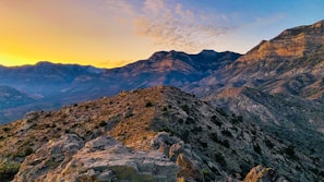 A vibrant landscape of the Kabylie mountains at sunset.