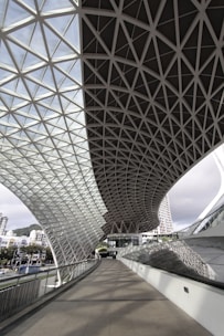 Elegant glass canopy over an entrance with sleek steel supports.