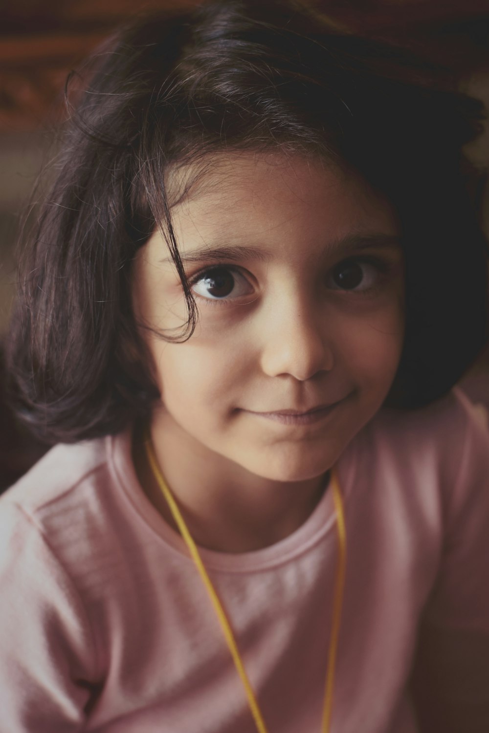 selective focus photography of smiling girl in pink shirt