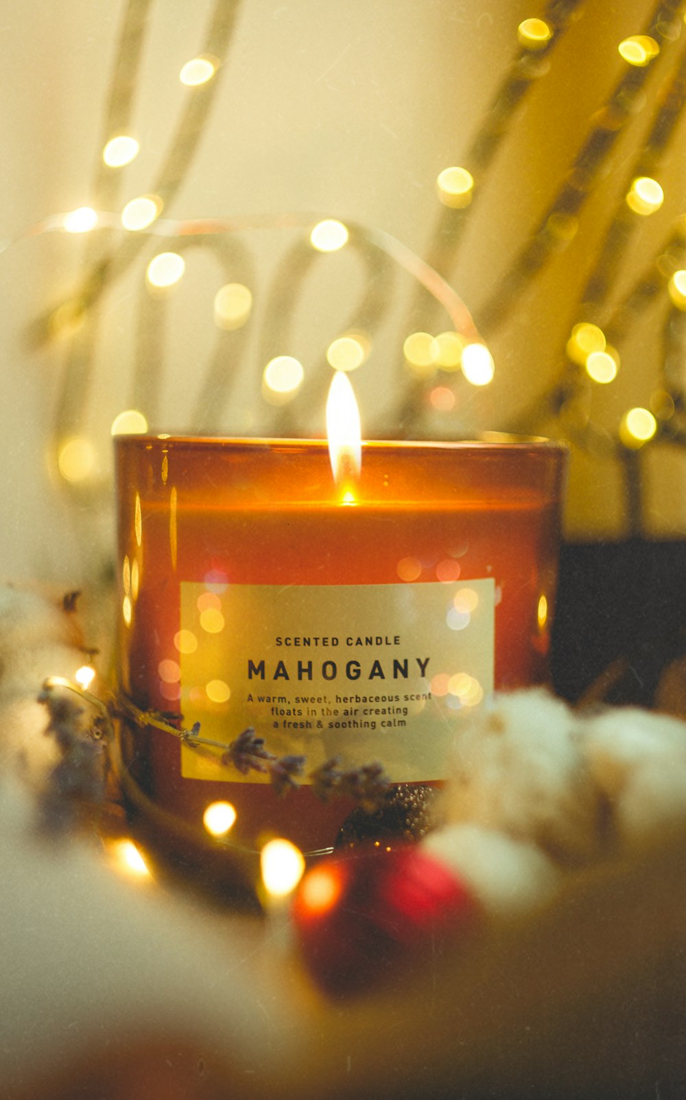 selective focus photography of lighted Mahogany scented candle