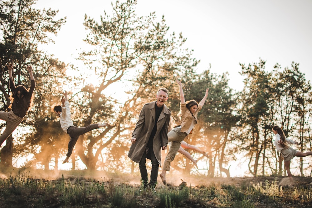 group of people dancing on grass field