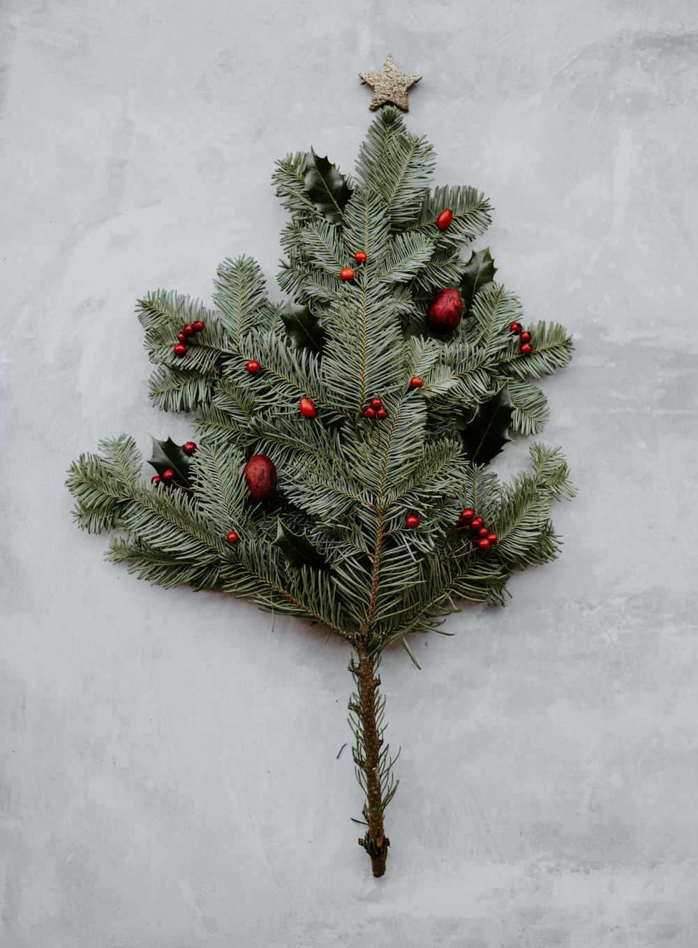 green pine leaves on gray surface