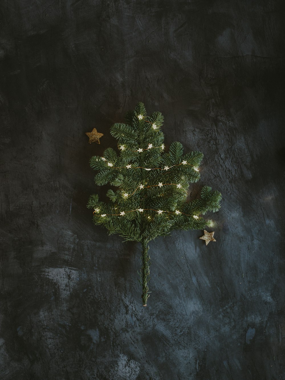 green Christmas tree on gray surface