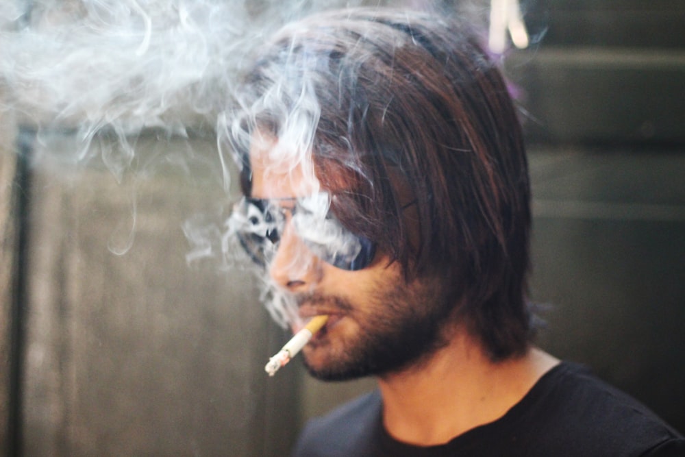 selective focus photography of smoking man