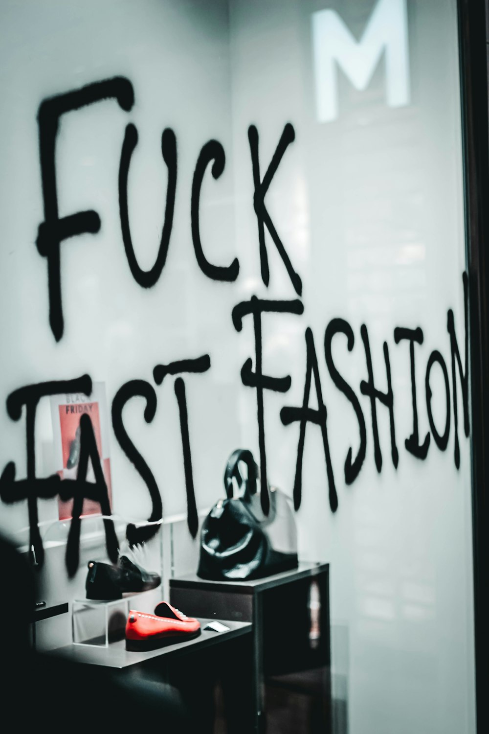 a store window with a sign that says f f k fast fashion
