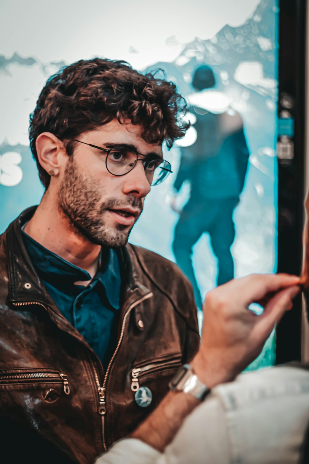 man wearing brown leather zip-up jacket