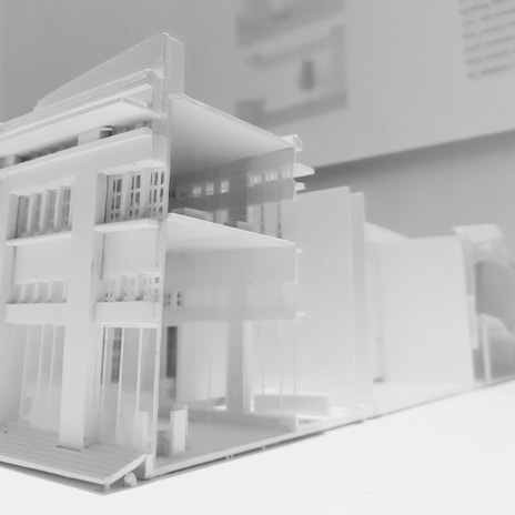 Architectural blueprint and model of a contemporary home design.