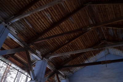 Warm wooden ceiling beams blending seamlessly with soft fabric drapes