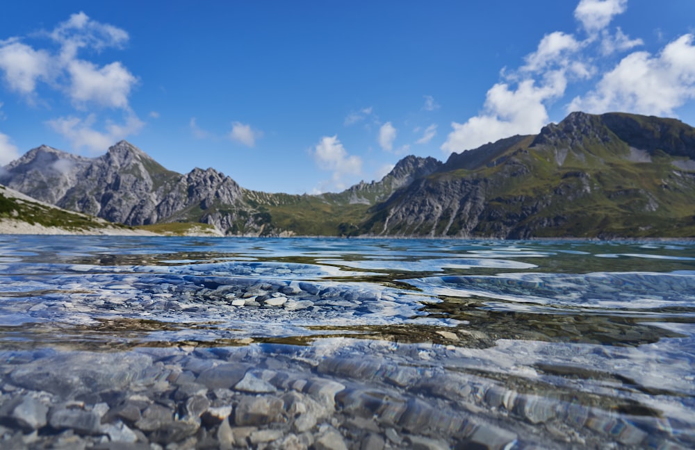 body of water beside hills