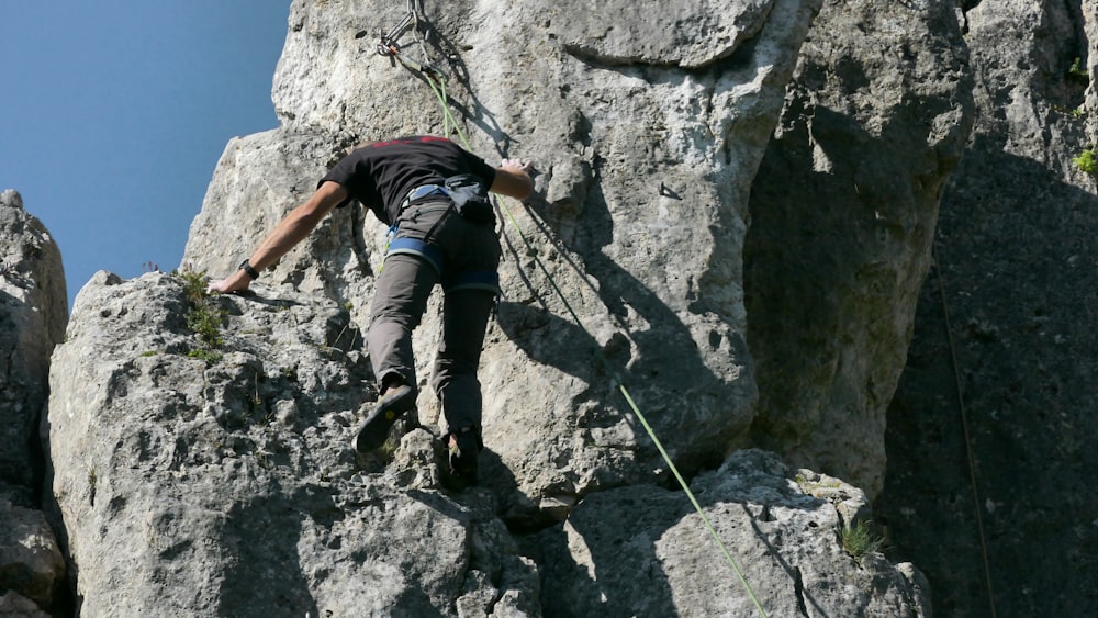 man climbing rock