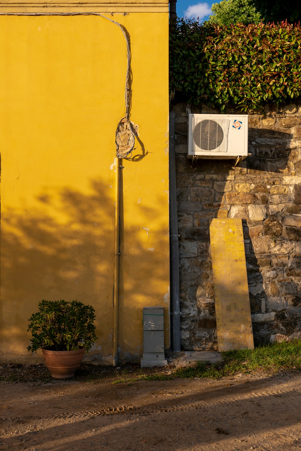 a yellow building with a street light next to it