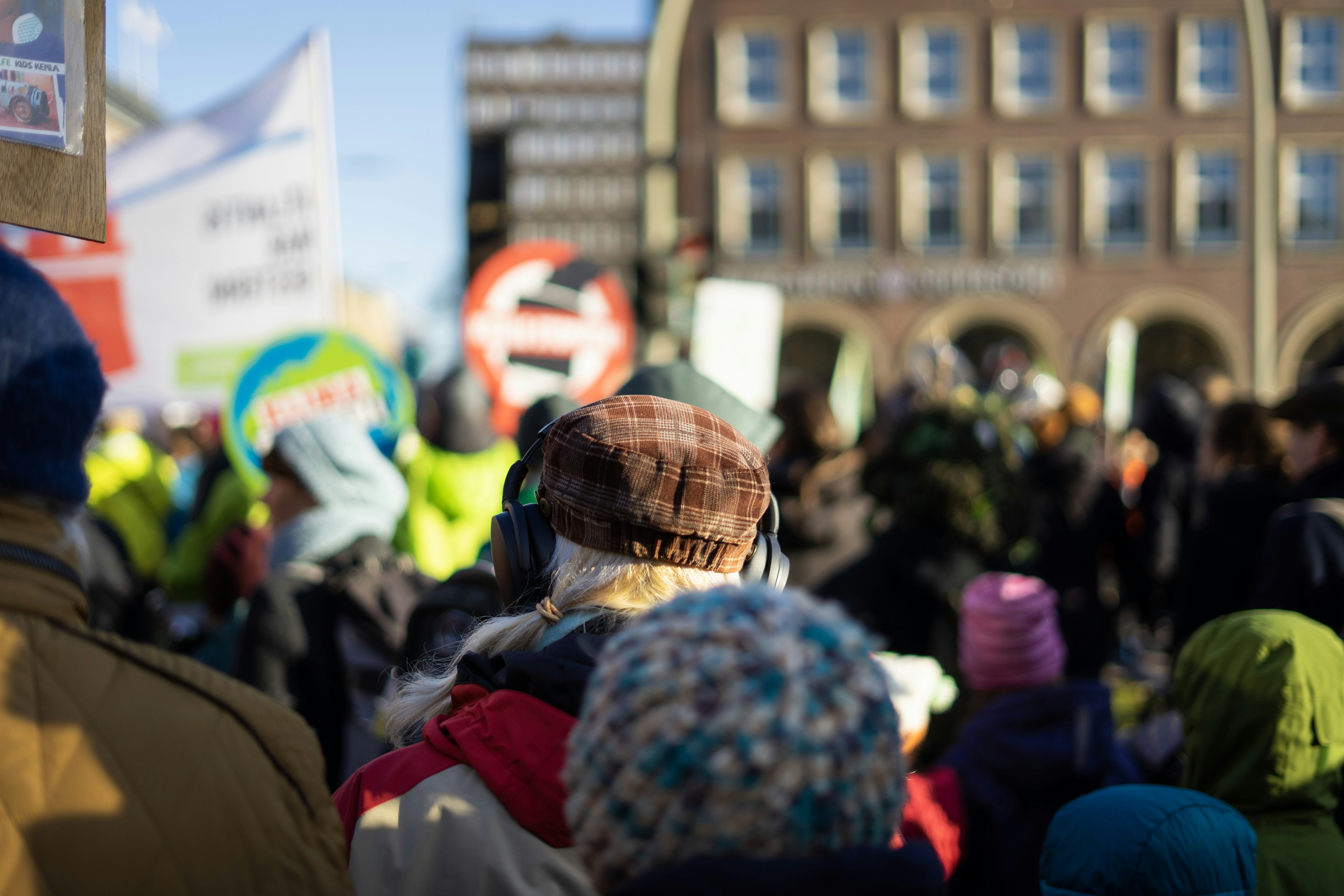 a crowd of people standing around each other
