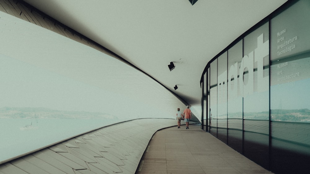 two walking people on hallway