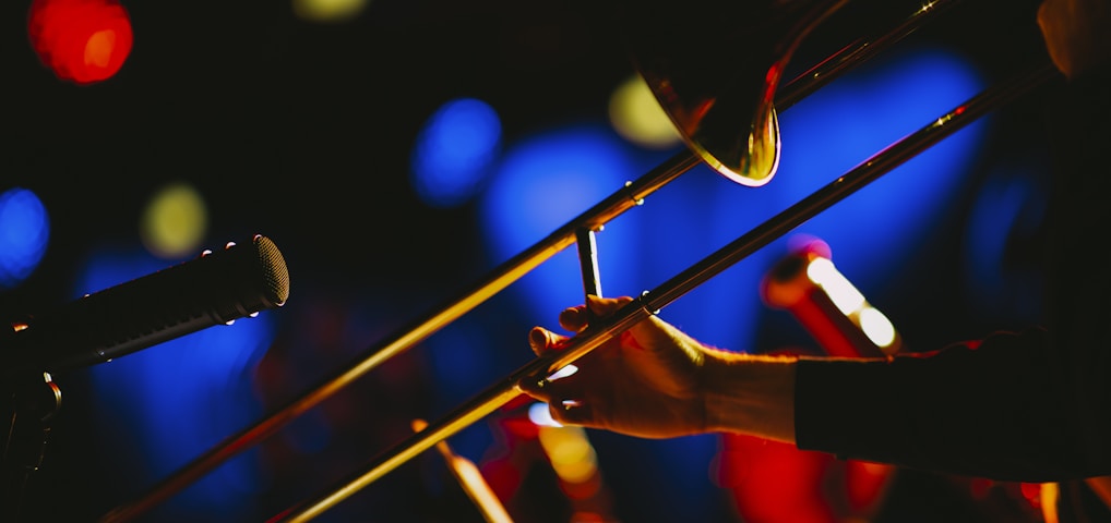 a close up of a person playing a trombone