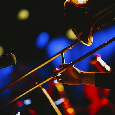 a close up of a person playing a trombone