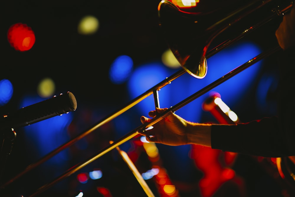 a close up of a person playing a trombone